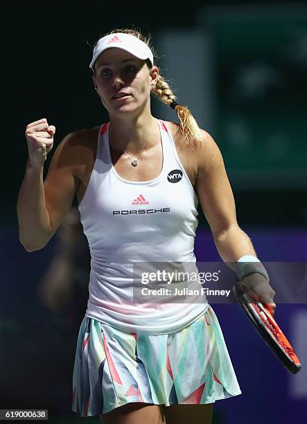 Angelique Kerber of Germany celebrates victory in her singles semi-final match against Agnieszka Radwanska of Poland during day 7 of the BNP Paribas...