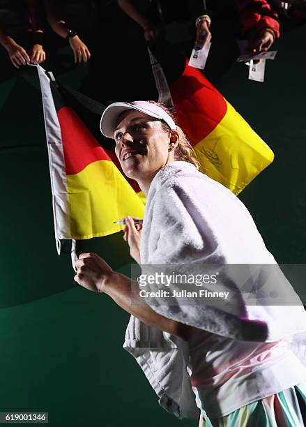 Angelique Kerber of Germany signs autographs after victory in her singles semi-final match against Agnieszka Radwanska of Poland during day 7 of the...