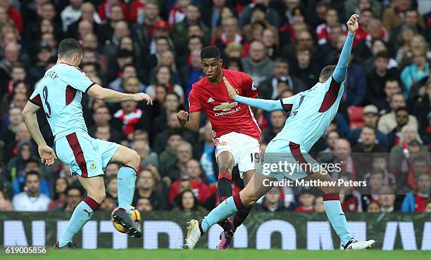 Marcus Rashford of Manchester United in action with Dean Marney and Michael Keane of Burnley during the Premier League match between Manchester...