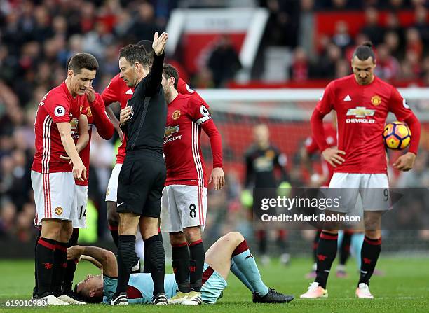 Ander Herrera of Manchester United protests to referee Mark Clattenburg after the red card during the Premier League match between Manchester United...