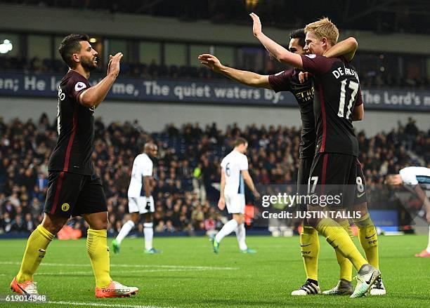 Manchester City's German midfielder Ilkay Gundogan celebrates with Manchester City's Belgian midfielder Kevin De Bruyne and Manchester City's...