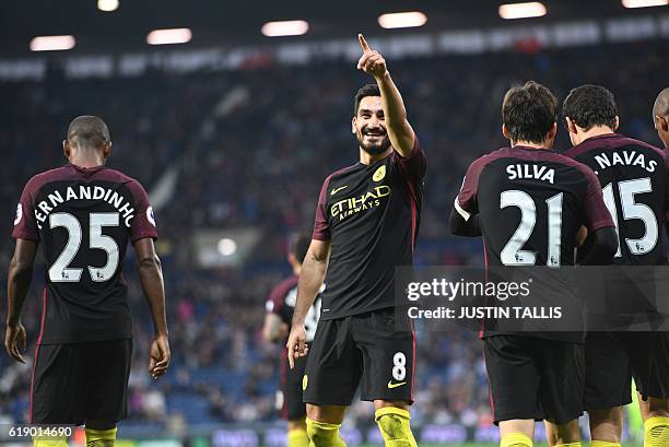 Manchester City's German midfielder Ilkay Gundogan celebrates after scoring their third goal during the English Premier League football match between...