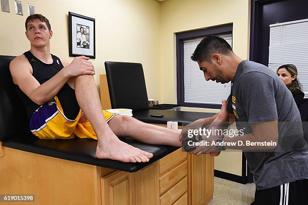 Timofey Mozgov of the Los Angeles Lakers gets taped up from trainer, Marco Nunez before the game against the Houston Rockets on October 26, 2016 at...