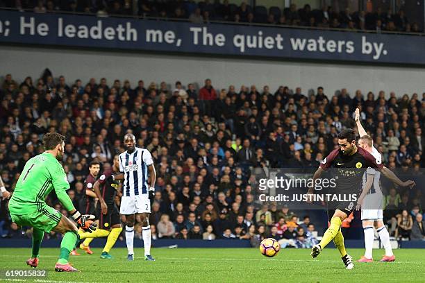 Manchester City's German midfielder Ilkay Gundogan shoots past West Bromwich Albion's English goalkeeper Ben Foster to score their third goal during...