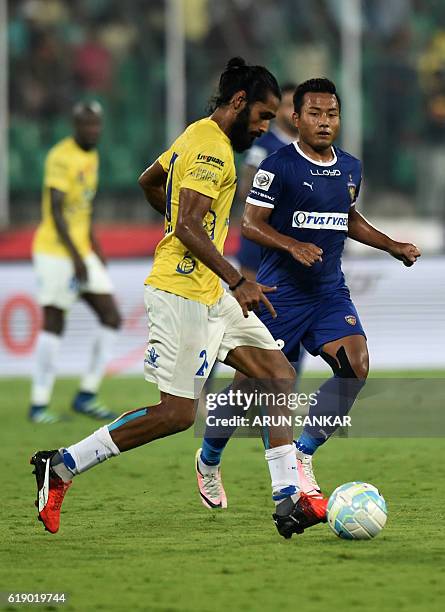 Chennaiyin FC's defender Abhishek Das vies for the ball with Kerala Blaster FC's defender Sandesh Jhingan during the Indian Super League football...