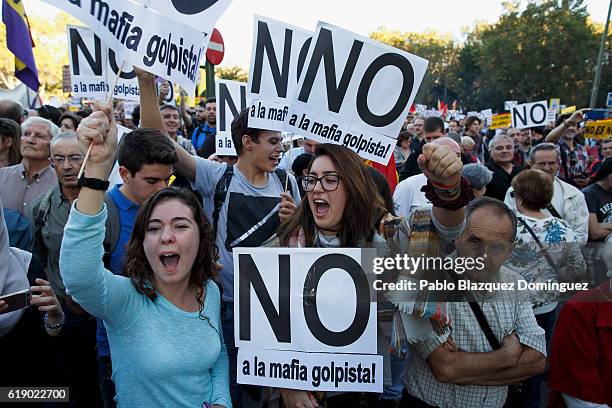 Demonstrators shout slogans and hold placards as the investiture debate takes place in the Spanish Parliament on October 29, 2016 in Madrid, Spain....