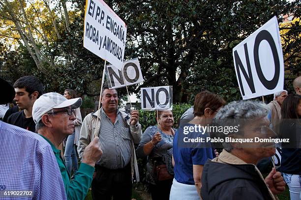 Demonstrators shout slogans and hold placards as the investiture debate takes place in the Spanish Parliament on October 29, 2016 in Madrid, Spain....
