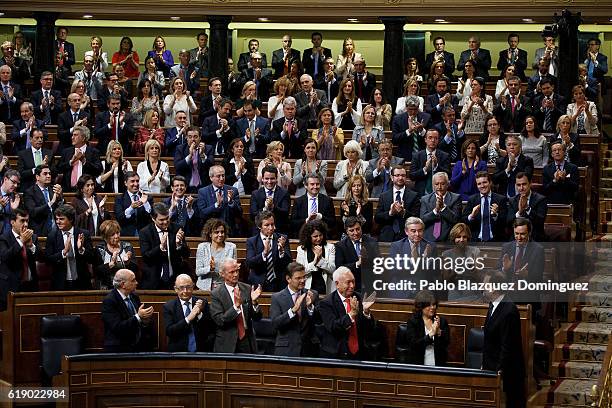 Popular Party deputies applause to acting Spanish Prime Minister Mariano Rajoy after his speech during the final day of the investiture debate at the...