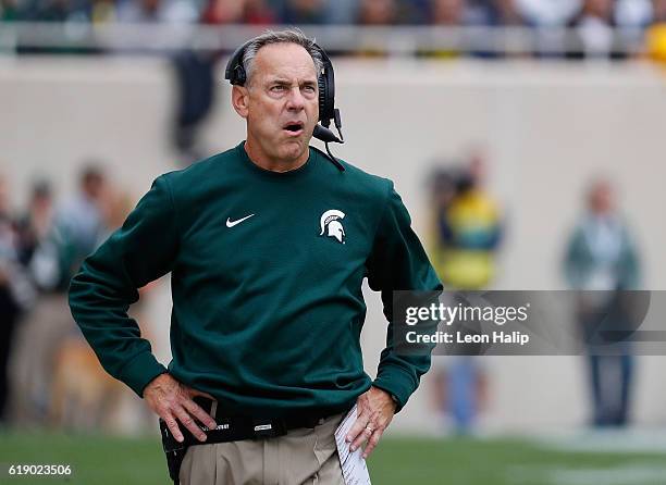 Michigan State Spartans head football coach Mark Dantonio watches the action during the first quarter of the game against the Michigan Wolverines at...