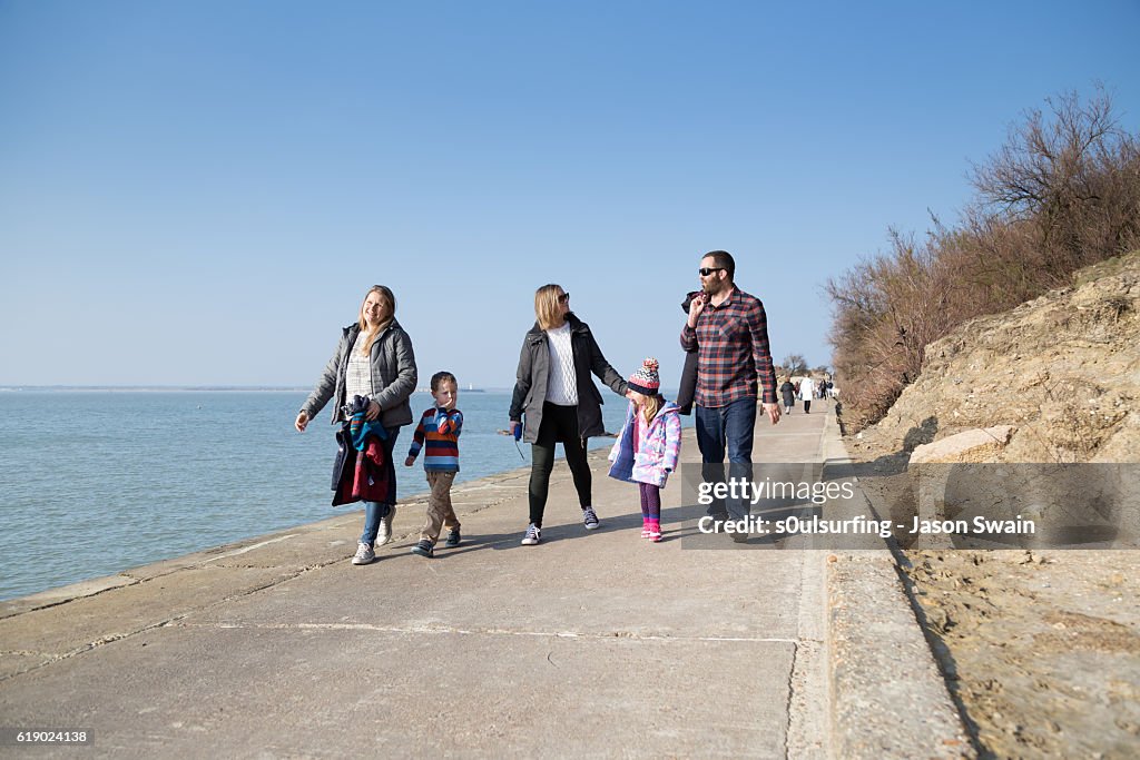 Family walk along the coast