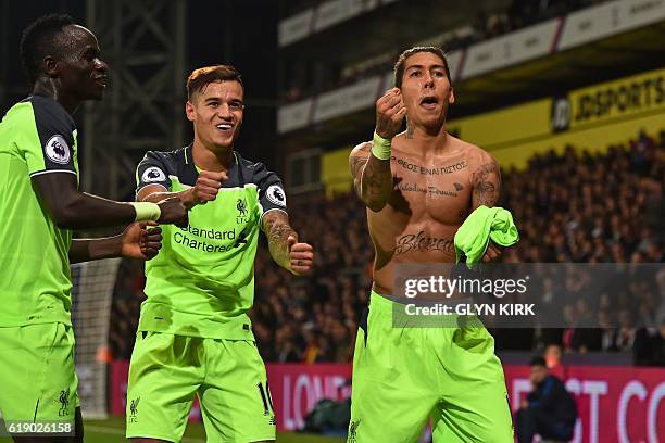 Liverpool's Brazilian midfielder Roberto Firmino celebrates with Liverpool's Senegalese midfielder Sadio Mane and Liverpool's Brazilian midfielder...