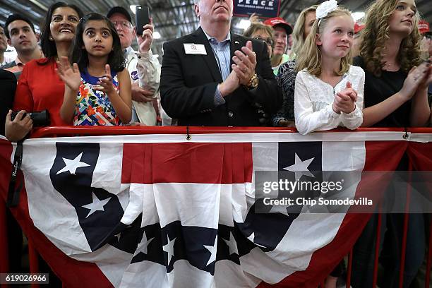 Young girls applaud for Republican presidential nominee Donald Trump as he addresses a campaign rally in the Rodeo Arena at the Jefferson County...