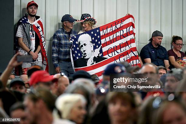 Supporters of Republican presidential nominee Donald Trump wait for his arrival for a campaign rally in the Rodeo Arena at the Jefferson County...