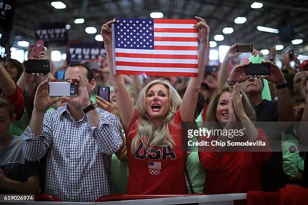 Supporters cheer for Republican presidential nominee Donald Trump as he arrives for a campaign rally in the Rodeo Arena at the Jefferson County...