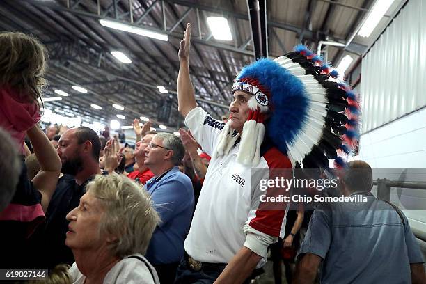 Man wearing an Indian American headdress attends a rally with Republican presidential nominee Donald Trump at the Rodeo Arena at the Jefferson County...