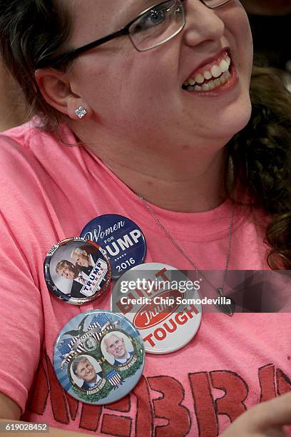 Woman wears campaign buttons during a rally for Republican presidential nominee Donald Trump in the Rodeo Arena at the Jefferson County Fairgrounds...