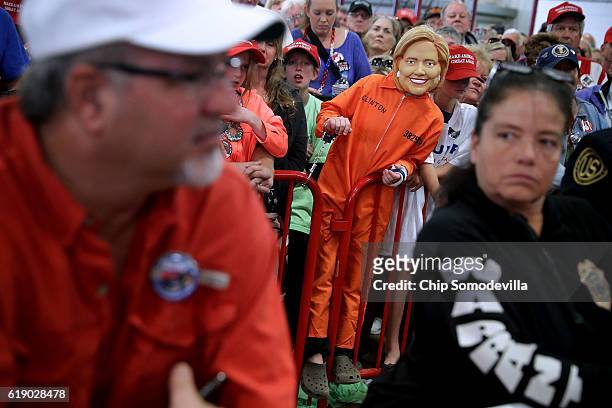 Young boy wears a Hillary Clinton mask during a rally with Republican presidential nominee Donald Trump in the Rodeo Arena at the Jefferson County...