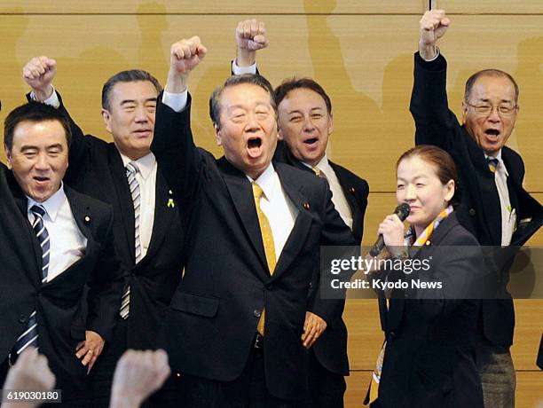 Japan - Veteran lawmaker Ichiro Ozawa and his party colleagues pump their fists during the inaugural convention of the People's Life Party in Tokyo...