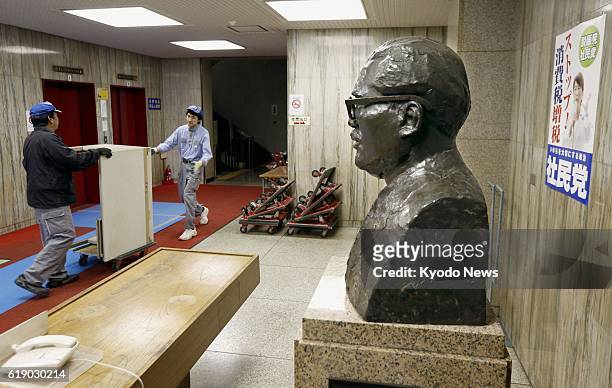 Japan - Photo shows removal workers in front of the bust of Inejiro Asanuma, the assassinated leader of the now-defunct Japan Socialist Party, at the...