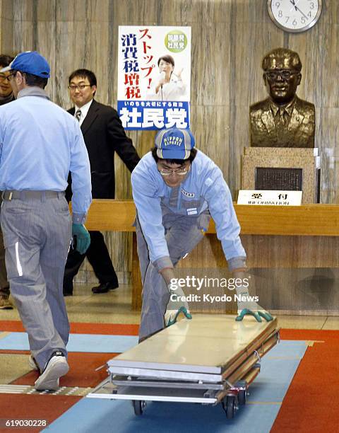 Japan - Photo shows removal workers in front of the bust of Inejiro Asanuma, the assassinated leader of the now-defunct Japan Socialist Party, at the...