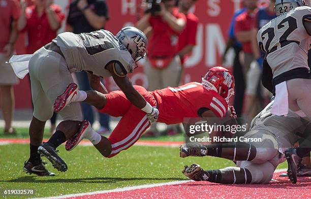 Quarterback Greg Ward, Jr. #1 of the University of Houston Cougars scores against defensive back Drico Johnson of the University of Central Florida...