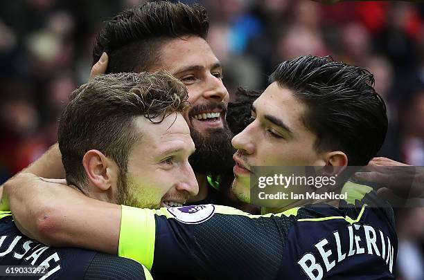 Olivier Giroud of Arsenalis congratulated on scoring his second goal during the Premier League match between Sunderland and Arsenal at Stadium of...