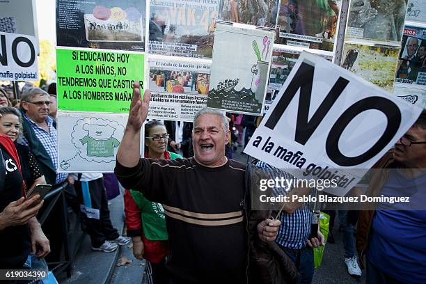 Demonstrator sings as he holds a placard while the investiture debate takes place near the Spanish Parliament on October 29, 2016 in Madrid, Spain....