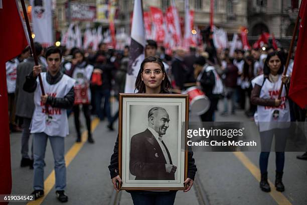 Woman holds a portrait of Mustafa Kemal Ataturk during a rally marking the 93rd Anniversary of Turkey's Republic day on October 29, 2016 in Istanbul,...