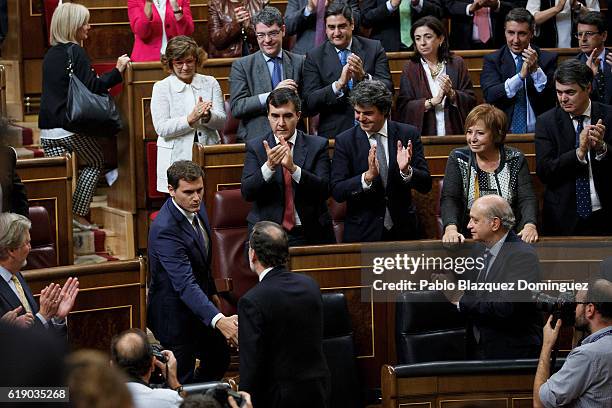 Acting Spanish Prime Minister Mariano Rajoy shakes hands with leader of Ciudadanos Albert Rivera after Rajoy won the investiture debate at the...