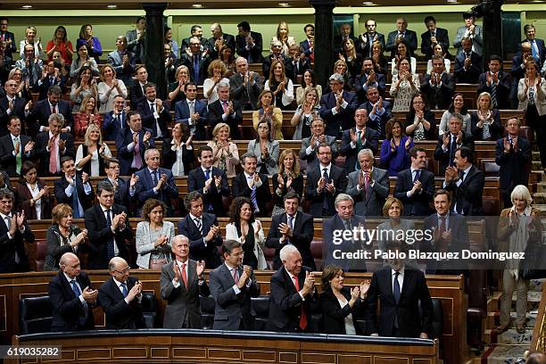 People's Party members applause to acting Spanish Prime Minister Mariano Rajoy after he won the investiture debate at the Spanish Parliament on...