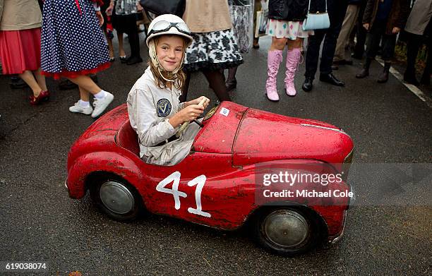 Catherine Collings, winner of the Settrington Cup race, on her way back to the paddock in the Austin J40 pedal car, entered by Felicity Collings, in...