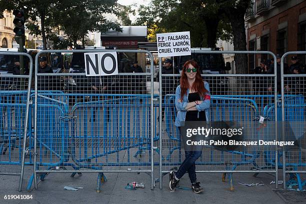 Demonstrator leans against the police barrier near the Spanish Parliament while the investiture debate takes place on October 29, 2016 in Madrid,...