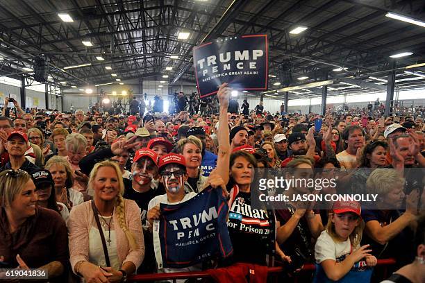 Supporters of Republican Presidential nominee Donald Trump cheer for him during a campaign rally at the Jefferson County Fairgrounds - Rodeo Arena &...