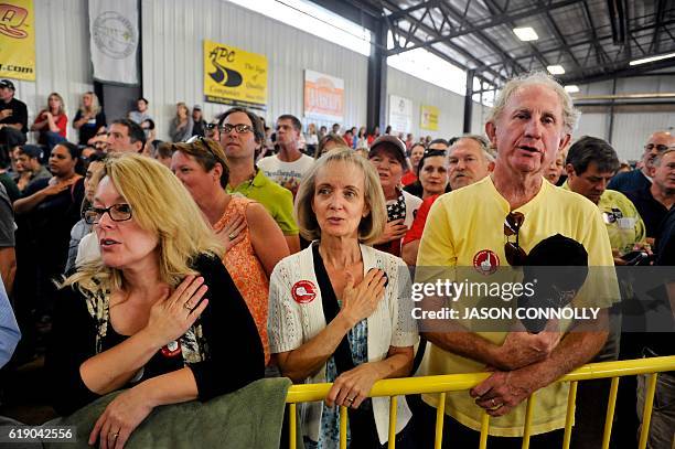 Supporters of Republican Presidential nominee Donald Trump recite the Pledge of Allegiance at the start of a campaign rally held at the Jefferson...