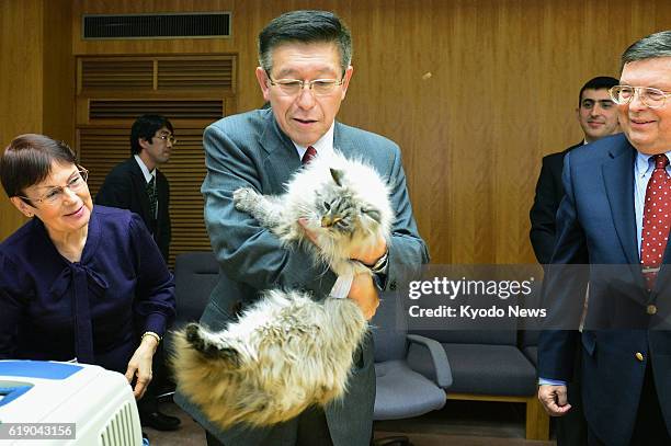 Japan - Akita Gov. Norihisa Satake holds a Siberian cat given as a gift by Russian President Vladimir Putin at the prefectural office building in...