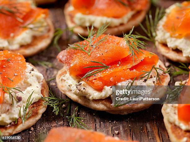 smoked salmon bilini with avocado cream cheese - canape stock pictures, royalty-free photos & images