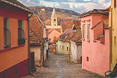 Stone paved old streets with colorful houses in Sighisoara