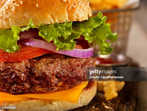 deluxe cheeseburger with a basket of fries - giant cheeseburger stock pictures, royalty-free photos & images