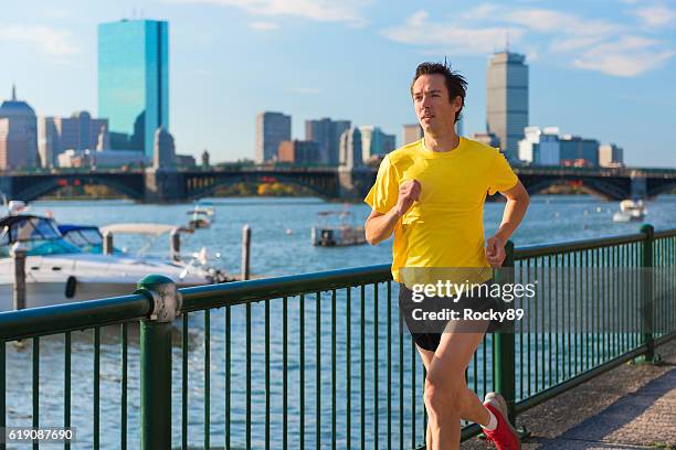 runner in front of boston's skyline - boston massachusetts summer stock pictures, royalty-free photos & images