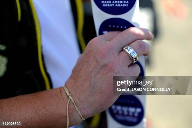 Republican presidential nominee Donald Trump supporter, Gayle Hardy, shows off her Trump ring while waiting in line outside of the Jefferson County...