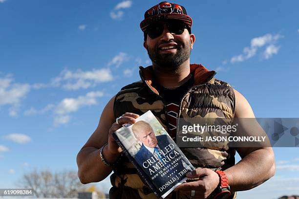 Supporter of Republican presidential nominee Donald Trump, waits in line outside of the Jefferson County Fairgrounds - Rodeo Arena & Event Center,...