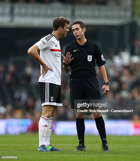 Referee Daivd Coote has words with Fulham's Kevin McDonald during the Sky Bet Championship match between Fulham and Huddersfield Town at Craven...