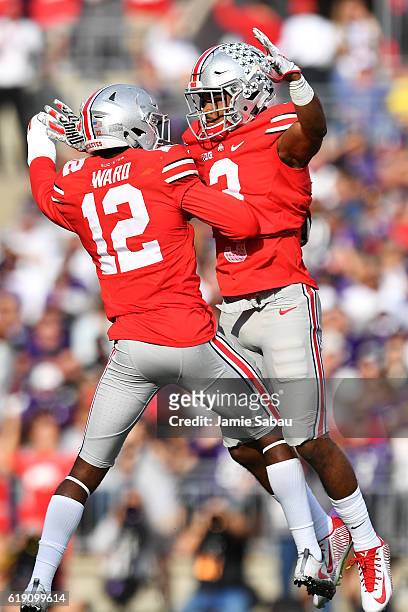 Denzel Ward of the Ohio State Buckeyes celebrates with Damon Arnette of the Ohio State Buckeyes after Arnette intercepted a pass in the first quarter...