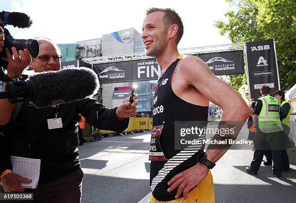 Oska Inkster-Baynes talks to the media after he crossed the finish line to win the ASB Auckland Marathon during the ASB Auckland Marathon Run Down...