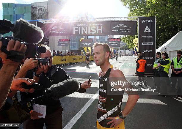 Oska Inkster-Baynes talks to the media after he crossed the finish line to win the ASB Auckland Marathon during the ASB Auckland Marathon Run Down...