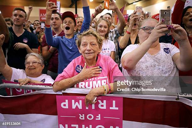 Woman weeps as she listens to Republican presidential nominee Donald Trump address a campaign rally at the Phoenix Convention Center, his seventh...
