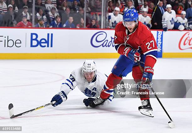 Alex Galchenyuk of the Montreal Canadiens controls the puck against Morgan Rielly of the Toronto Maple Leafs in the NHL game at the Bell Centre on...