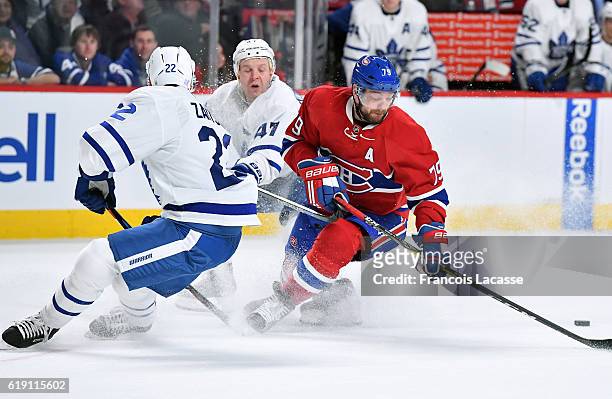 Andrei Markov of the Montreal Canadiens loses control of the puck against Nikita Zaitsev of the Toronto Maple Leafs in the NHL game at the Bell...