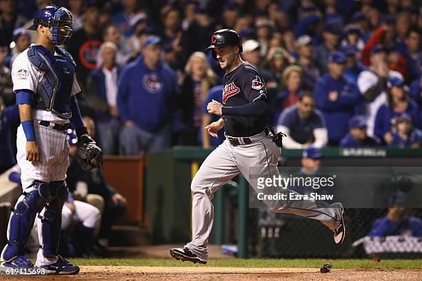 Lonnie Chisenhall of the Cleveland Indians scores a run past Willson Contreras of the Chicago Cubs in the second inning in Game Four of the 2016...
