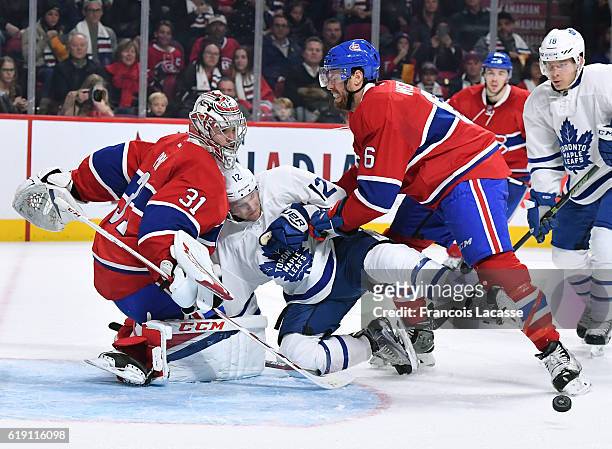 Carey Price and Shea Weber of the Montreal Canadiens protect the net against Connor Brown of the Toronto Maple Leafs in the NHL game at the Bell...